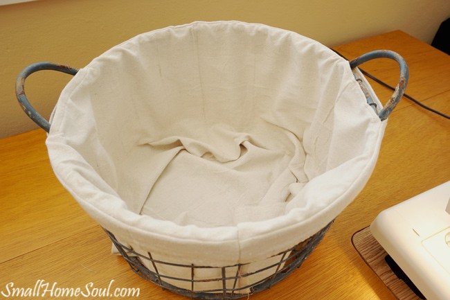Make your own drop cloth basket liner, without a pattern, using the steps in this tutorial by www.smallhomesoul.com. It will show off the beauty and details your wire baskets.