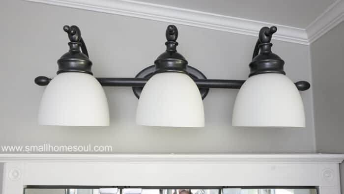 I love the finish on this bathroom light makeover. It looks brand new!