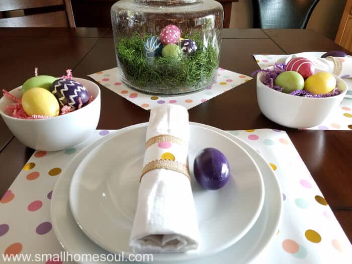 Easter table decorations looking at glass centerpiece.